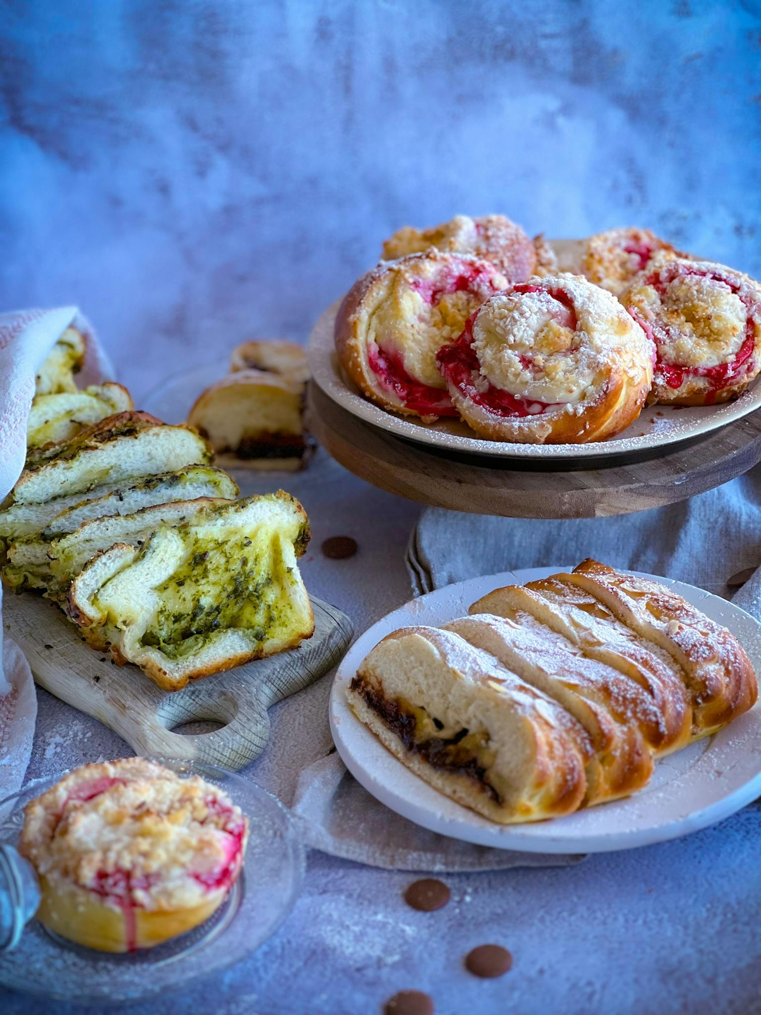 A variety of fresh pastries and bread including fruit and pesto flavoured options.