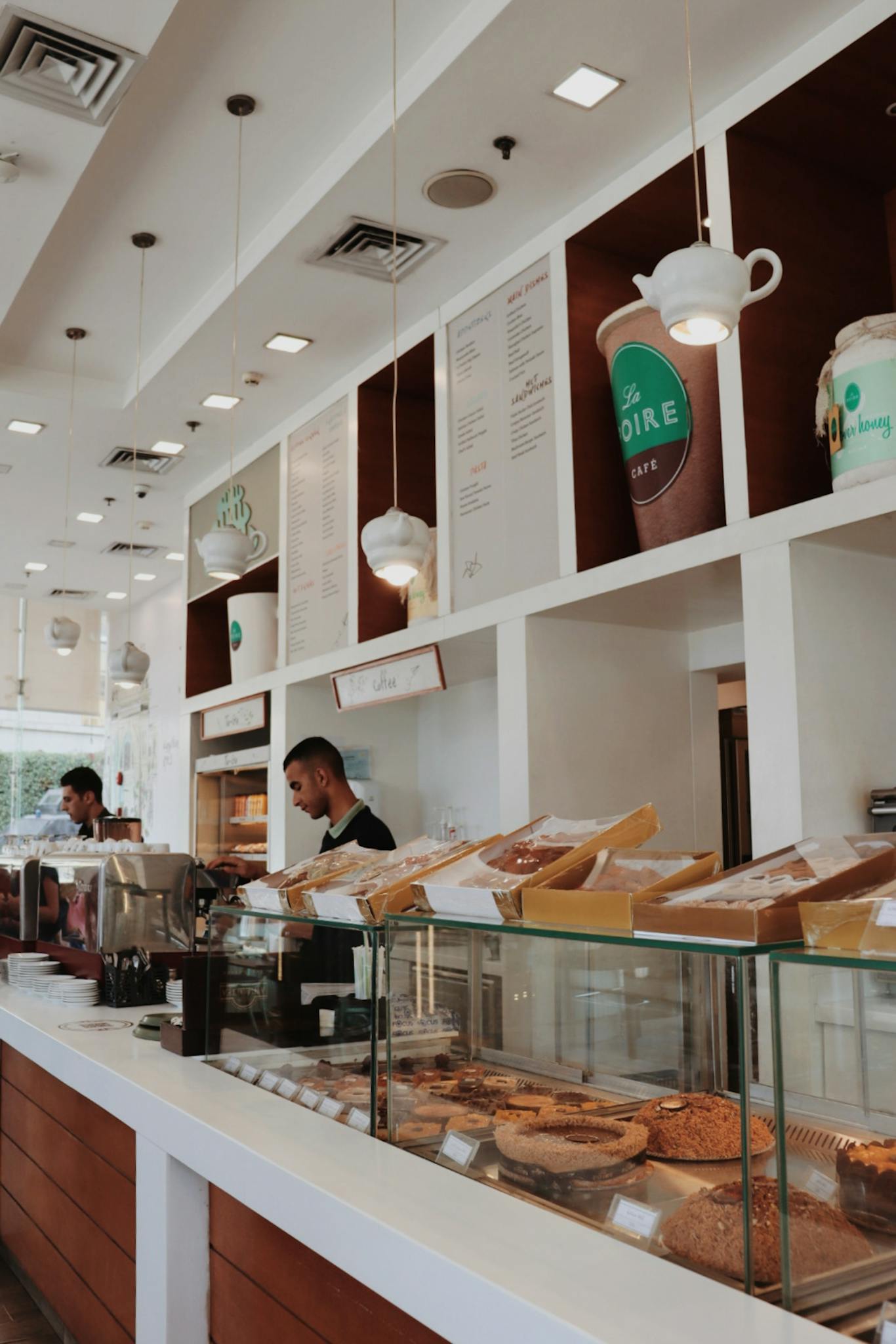 A well-lit bakery with a modern design featuring a variety of pastries on display. Perfect for food lovers.