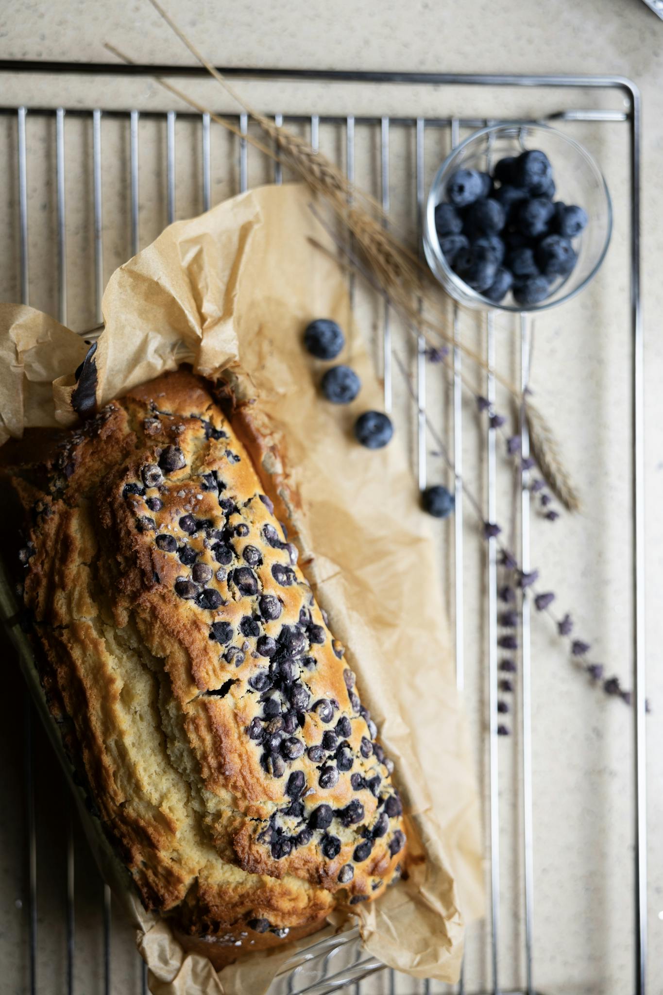Delicious homemade blueberry cake with fresh berries on parchment paper.