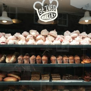 Explore the delightful display of baked goods at St Ives Bakery with fresh loaves and pastries.